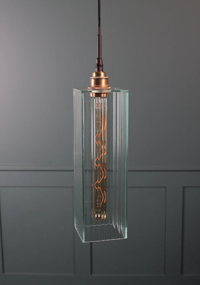 Long rectangular fluted glass bathroom pendant light with brushed brass lamp holder.