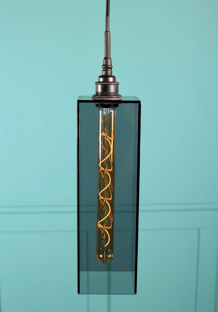 Elongated medium size rectangular smoked glass bathroom pendant light with antique bronze lamp holder. 