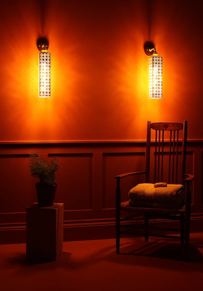 Elegant Moroccan style gold leaf IP44 bathroom wall lights, wooden chair with bath towels, plot plant