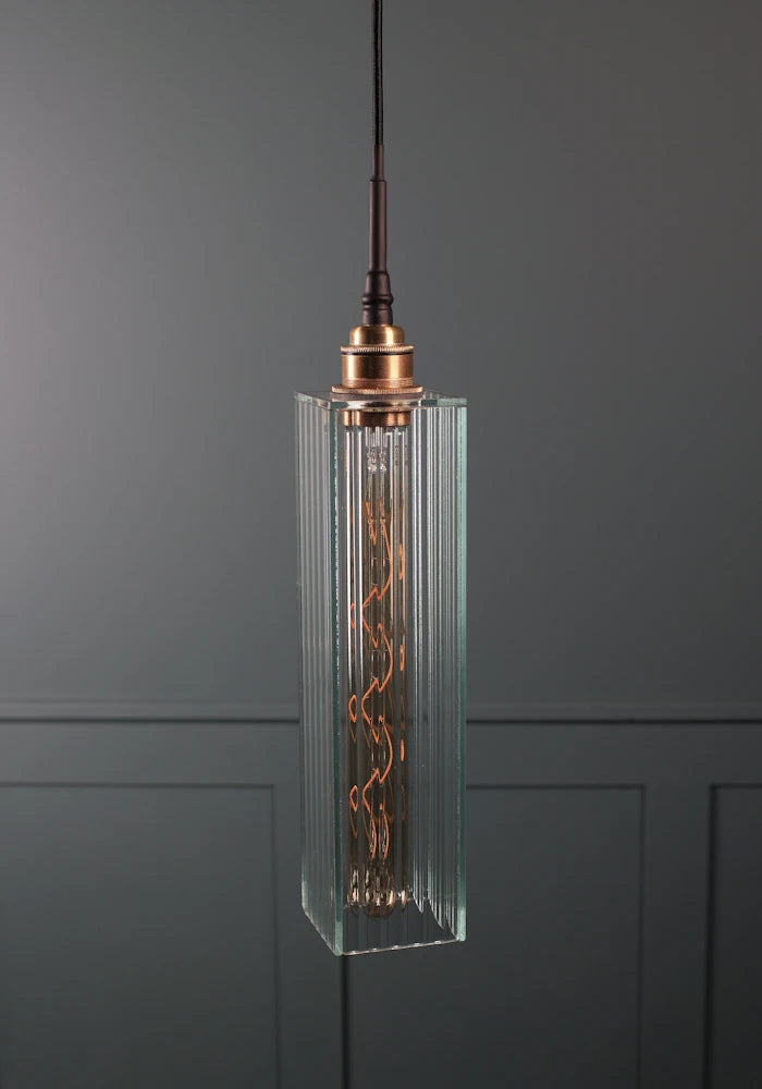 Rectangular ribbed glass bathroom pendant light with brushed brass lamp holder.