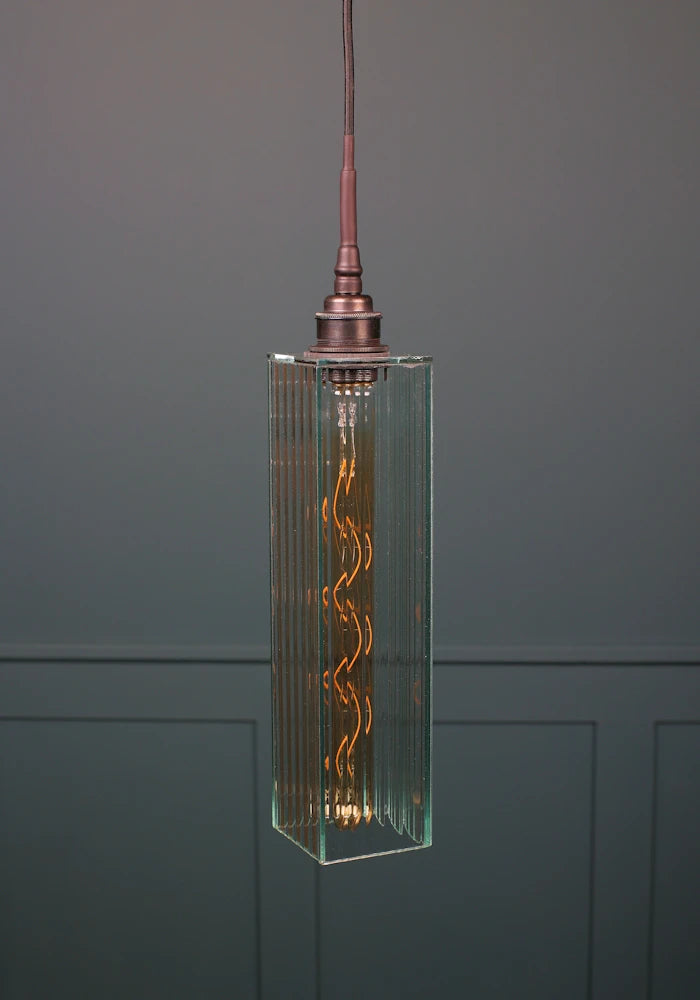 Rectangular ribbed glass bathroom pendant light with antique bronze lamp holder.