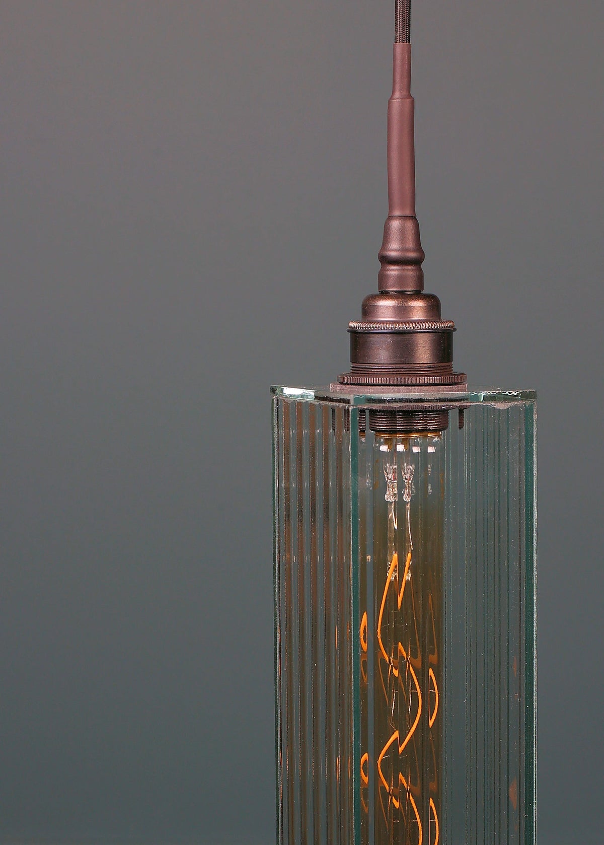 Long rectangular ribbed glass bathroom pendant light with antique bronze lamp holder