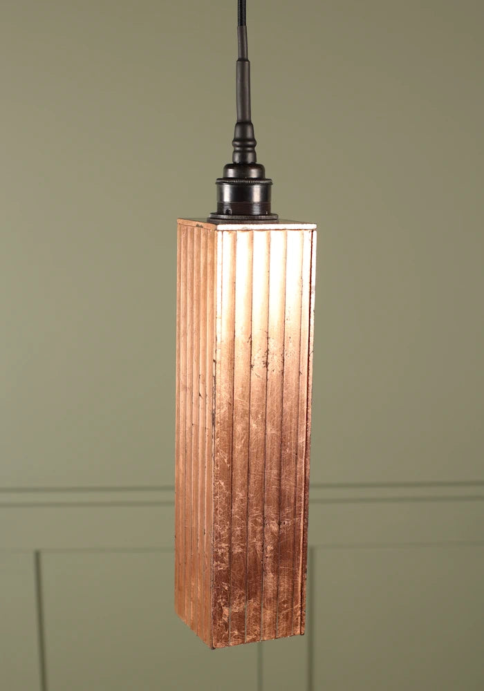 Elongated copper leaf bathroom pendant light with antique bronze lamp holder.