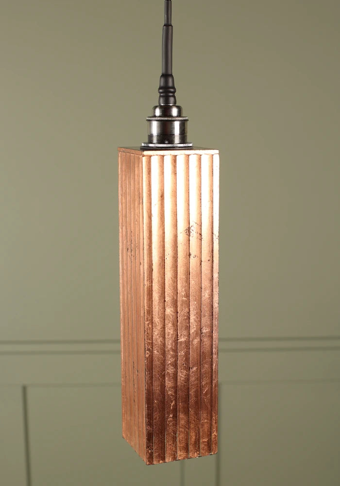 Elongated copper leaf bathroom pendant light with brushed nickel lamp holder.