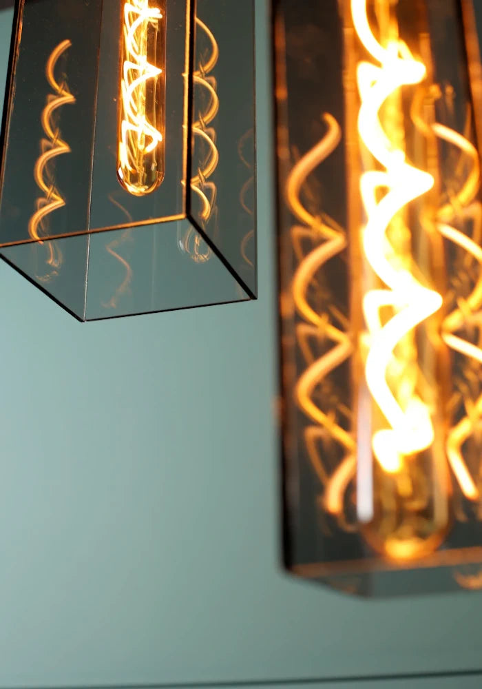 Close up elongated rectangular smoked glass bathroom pendant light.