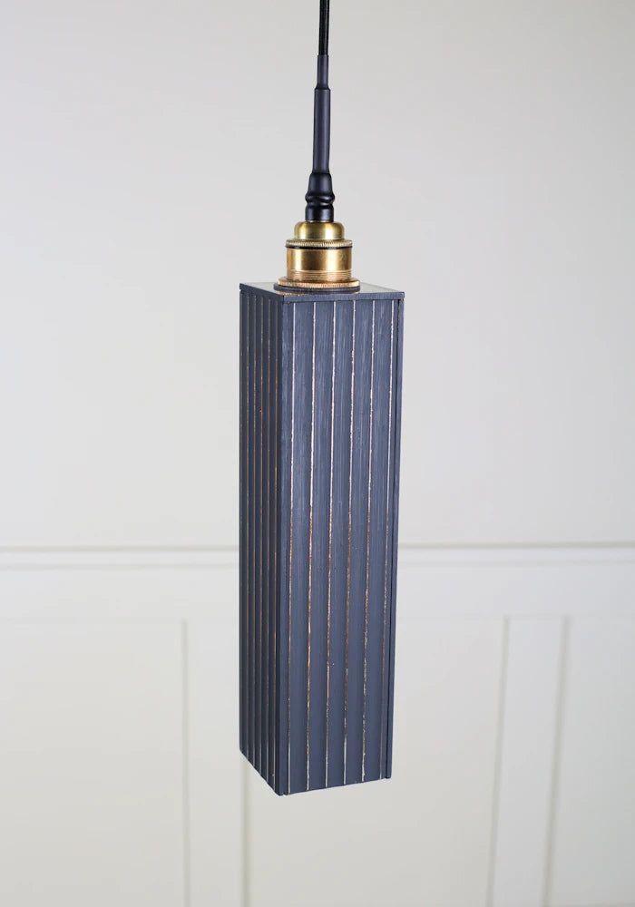 Black and gold bathroom ribbed glass pendant light with brushed brass lamp holder.