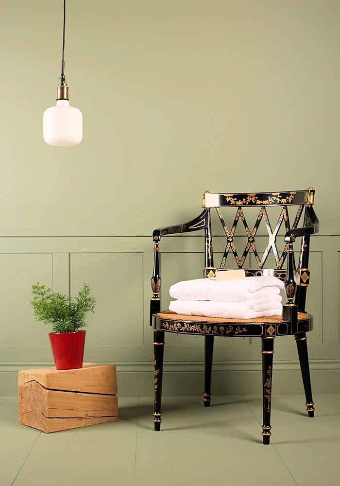 Tala Oblo bathroom pendant light switched off, plant and ornate chair.