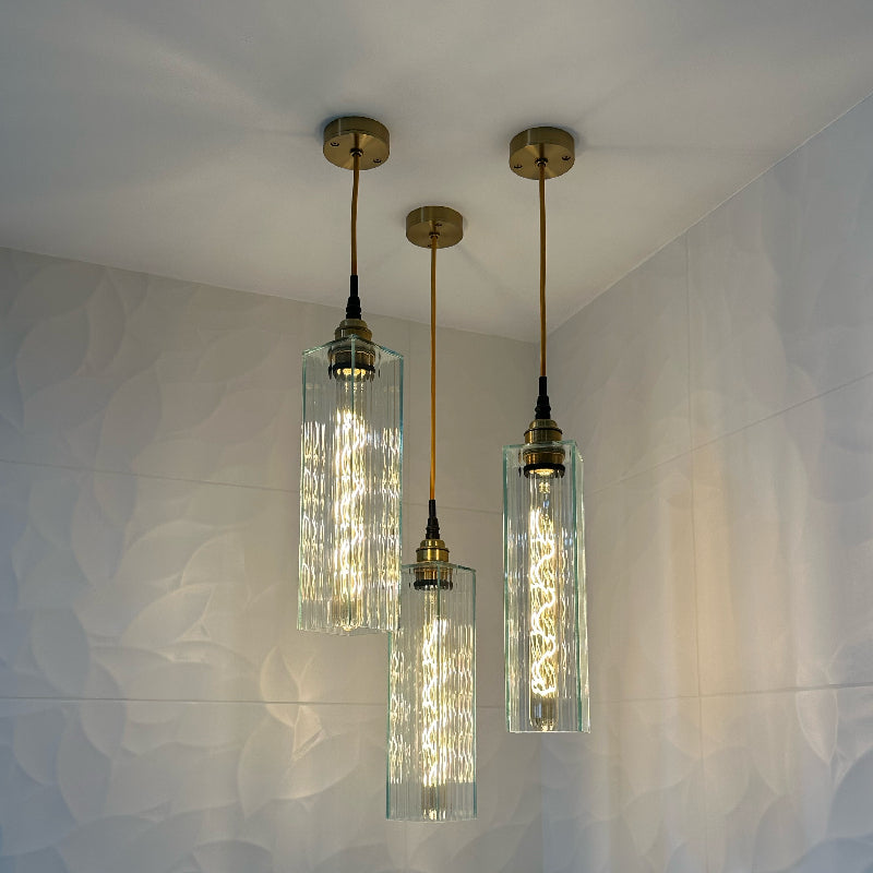 Reeded glass bathroom pendant lights hanging from brass ceiling rose