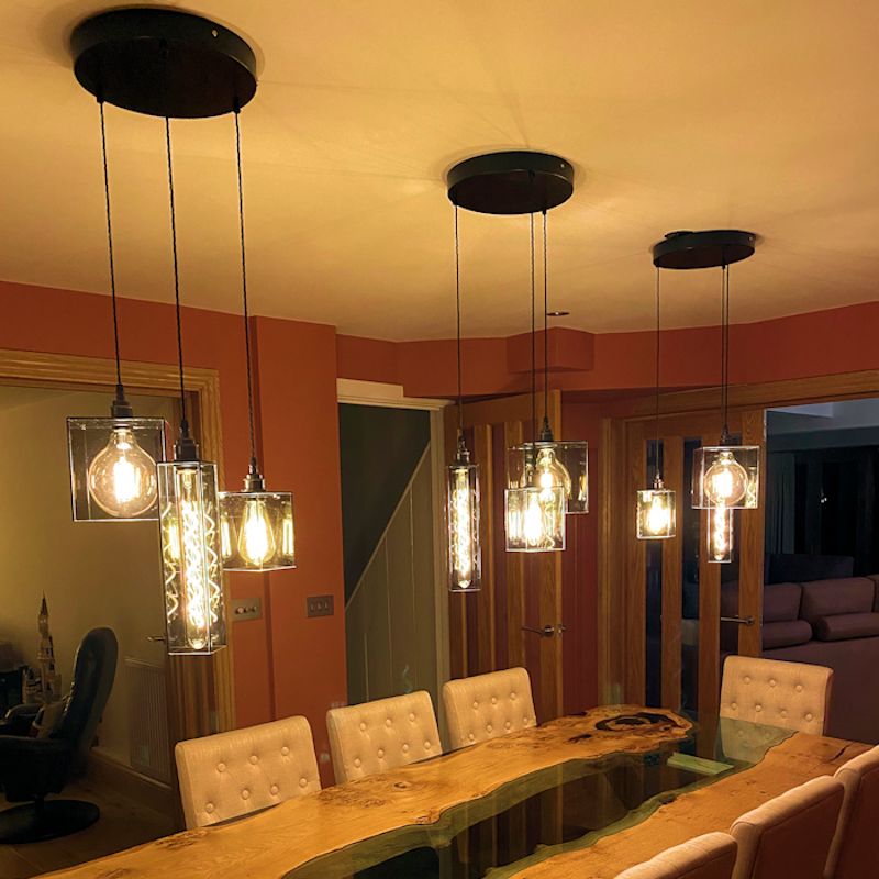 Modern interior with smoked glass pendant lights and a wooden table.