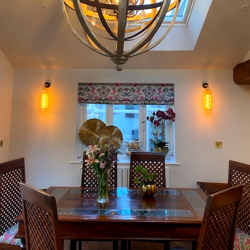 Decorative Moroccan style gold wall lights with wooden dining table and chairs 