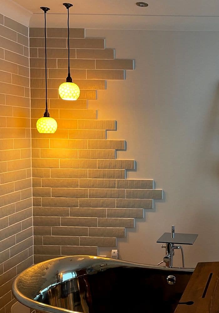 Two porcelain glowing bathroom pendant lights in modern bathroom.